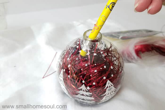 Pencil pushes tinsel for easy ornament updates.