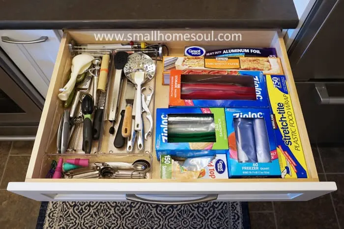 Kitchen utensil drawer after bin organization with plastic bags and aluminum foil