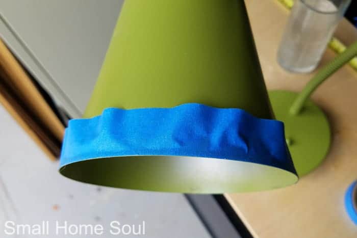 Taping off rim of light cover for desk lamp makeover.
