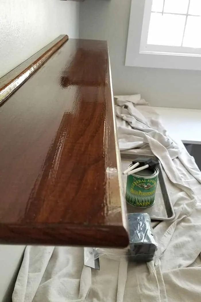 Final top coat on floating wood shelves is glossy.