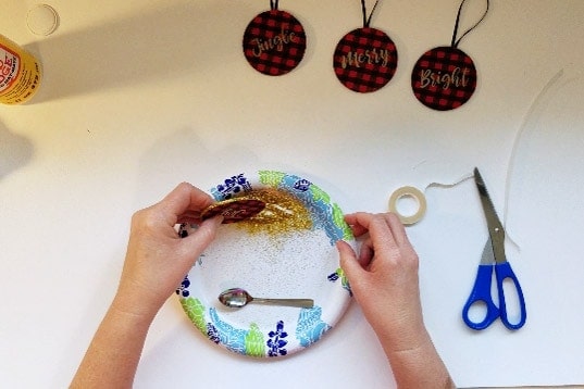 Buffalo plaid ornaments get edged in gold glitter.