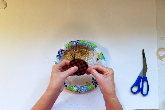 Pinch glitter into tape on edge of buffalo check ornaments.