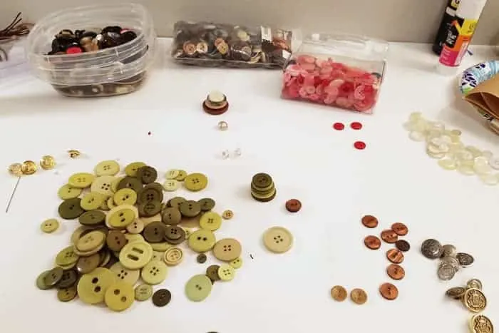 Green buttons on table preparing to make button ornaments.