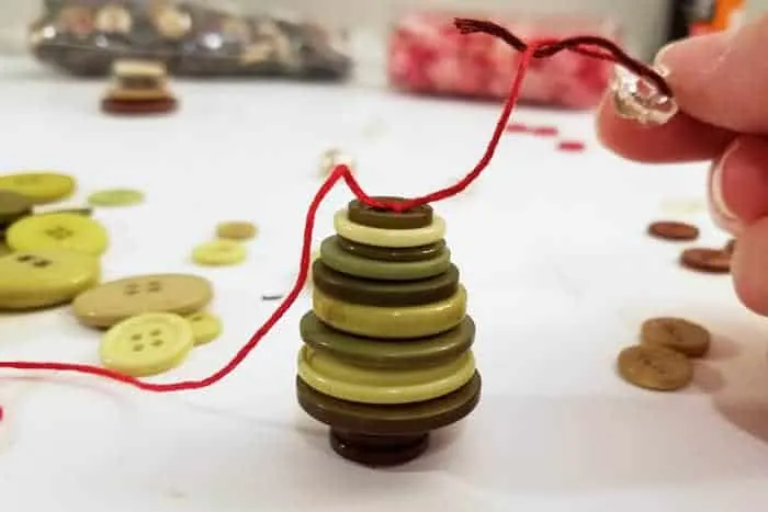Tie at top of stacked green buttons into a Christmas tree.