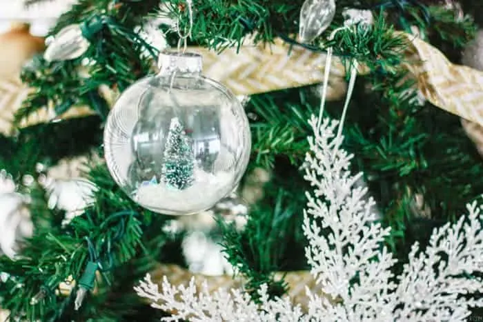 Snow globe DIY Christmas Ornaments with green christmas trees inside.