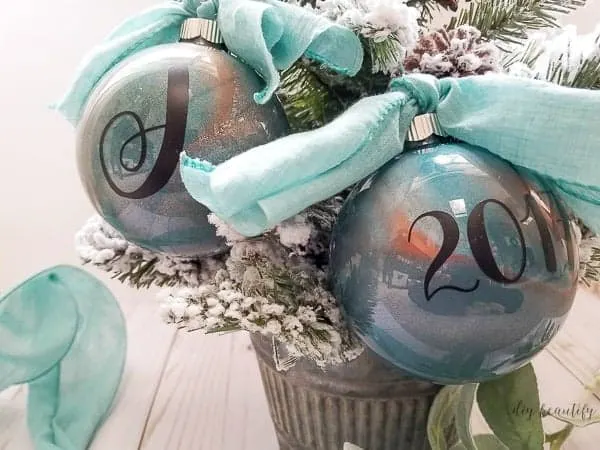 Metallic DIY Christmas Ornaments with Monograms and blue ribbon hangers.