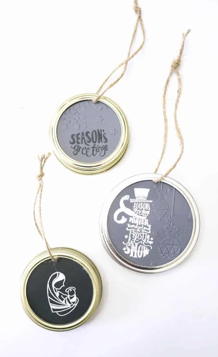 DIY Christmas Ornaments with embossed paper inside mason jar lids.