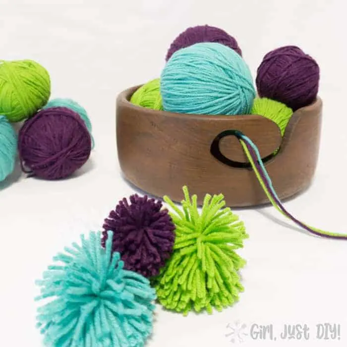 DIY yarn bowl filled with blue, purple, and green yarn.