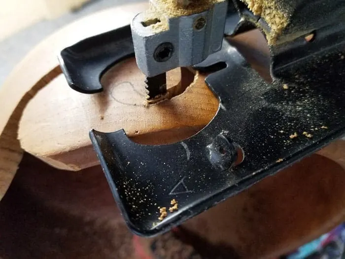 Jigsaw cutting swirl pattern in wooden yarn bowl.