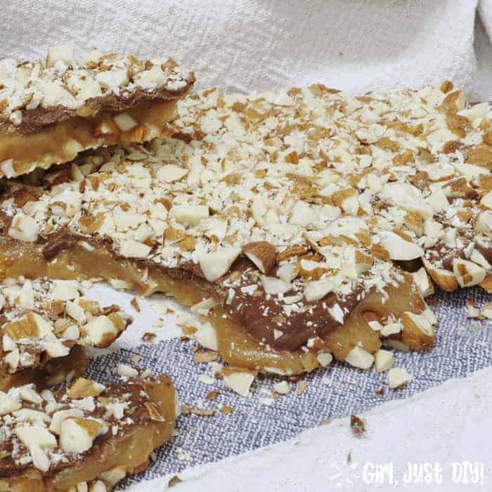 Homemade english toffee on blue kitchen towel.