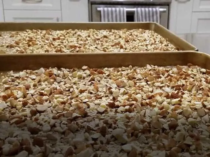 Chopped almonds spread on cookie sheet.