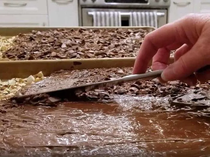 Spreading melted chocolate with knife.