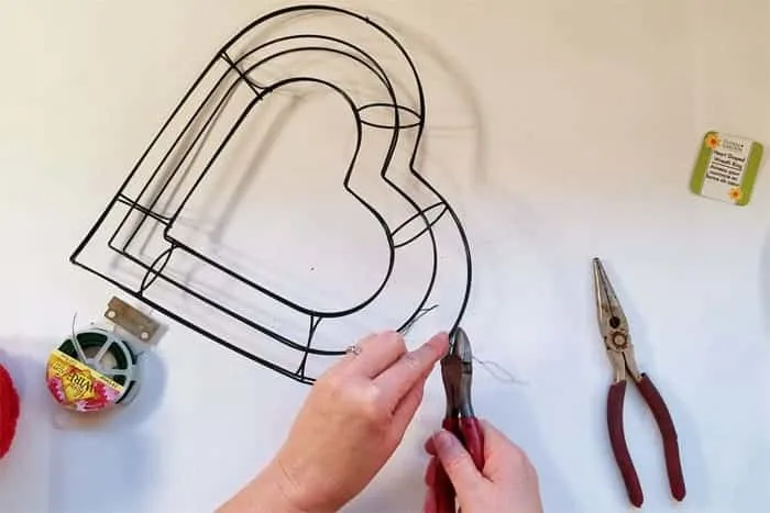 Hear-shaped wire wreath forms getting wired together.
