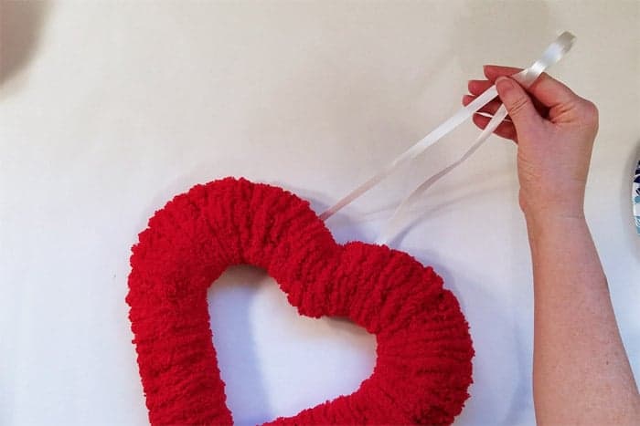 Front of valentine wreath showing white ribbon hanger on back.