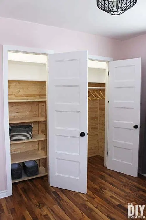 Side-by-side closets with built in closet shelves.