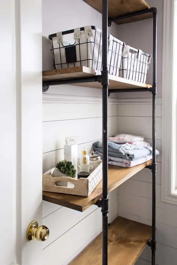 Pipe shelves with wooden shelves and bathroom suppllies