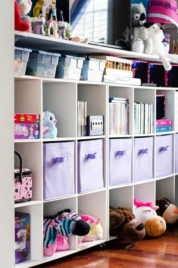 Cube storage in playroom filled with books and toys.