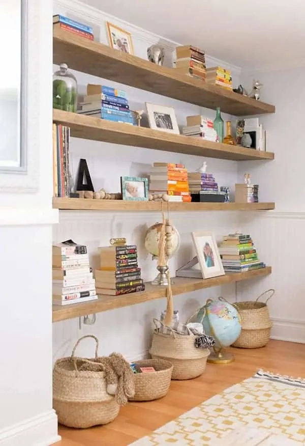 Floating shelves on long wall with books and decor.