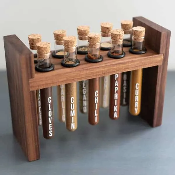 Test tubes on wooden rack filled with spices.