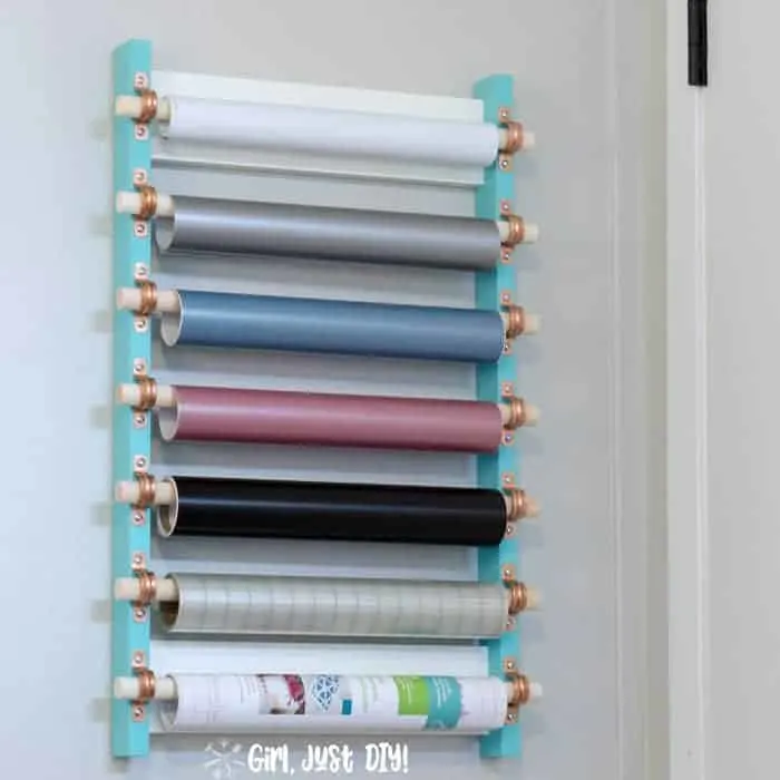 Craft vinyl strorage rack mounted on wall behind door.