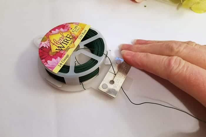 Cutting strips of floral wire for hydrangea wreath.