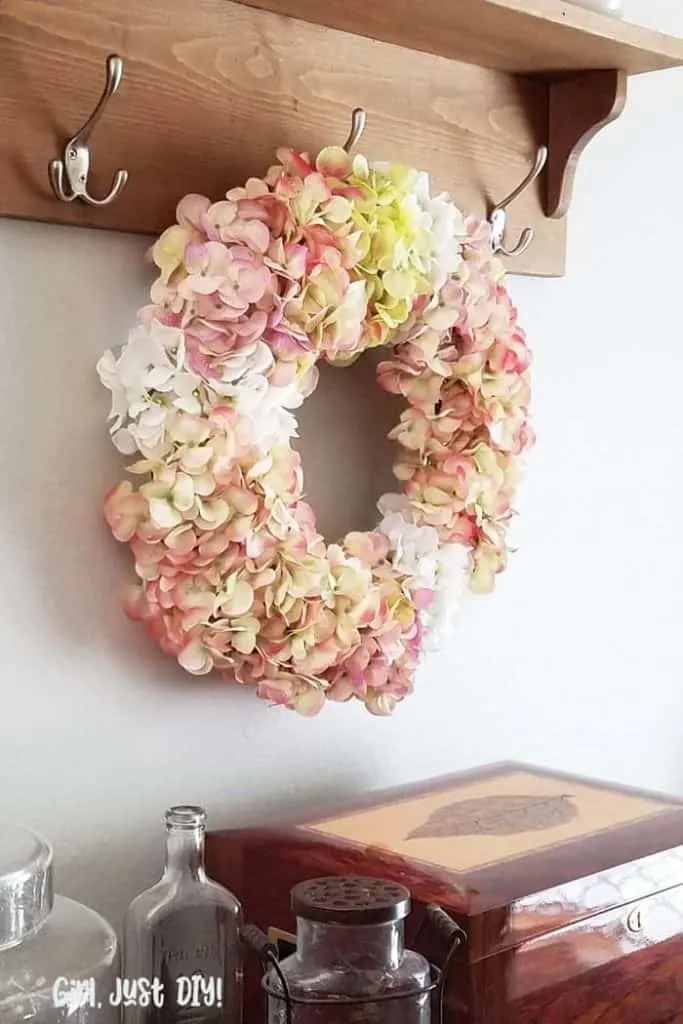 Faux Hydrangea wreath hanging on hook in dining room.