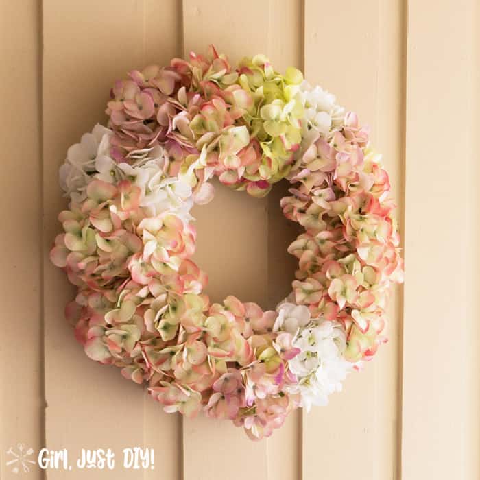 Faux hydrangea wreath hanging on porch wall