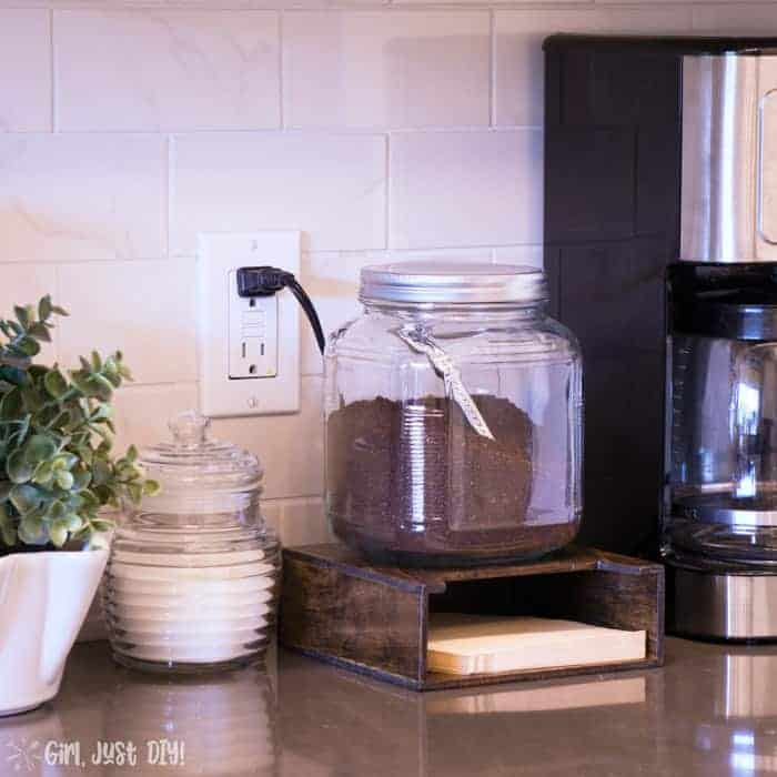 Wood coffee filter holder on counter top next to coffee maker.