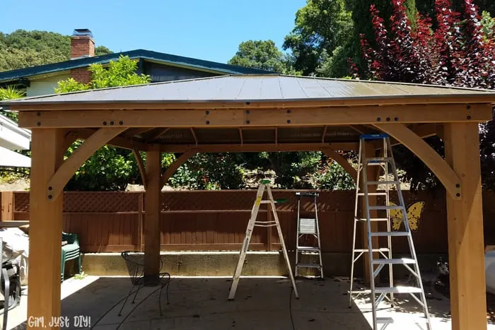 Fully installed diy patio gazebo with ladders underneath.