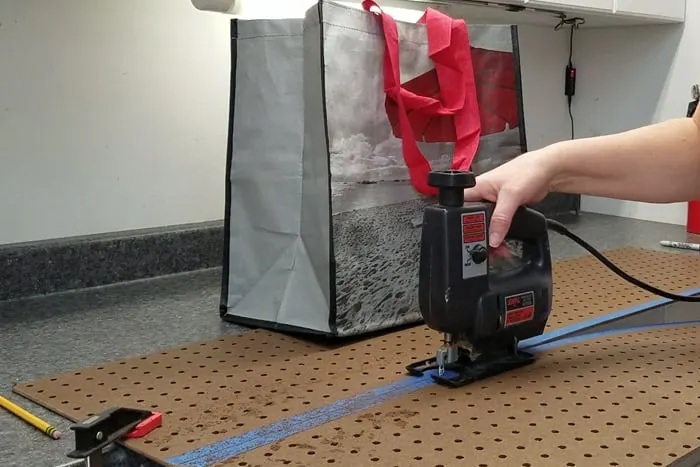 Cutting pegboard with a jigsaw.