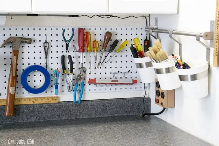 Screwdrivers and pliers hanging form pegboard installation.