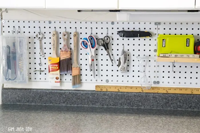 Tolls hanging on installed pegboard wall.
