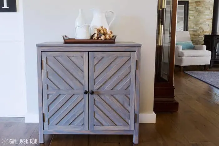 New DIY Chevron Storage Cabinet against wall next to grandfather clock.