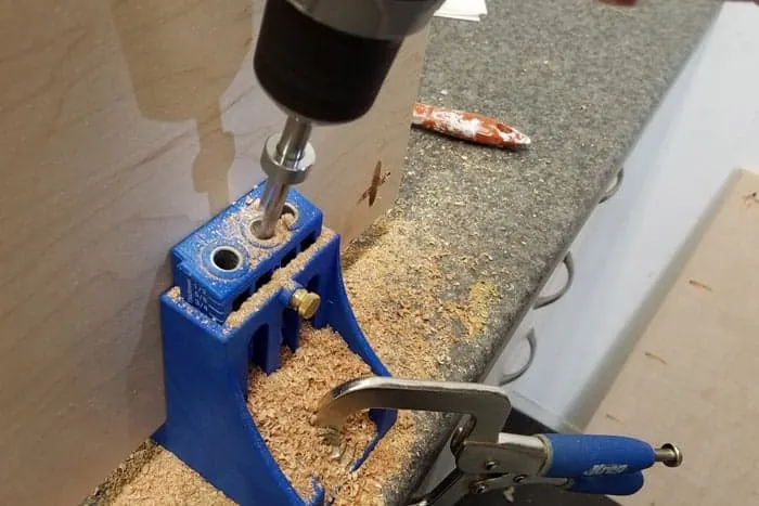 Closeup of drilling pocket holes into plywood.