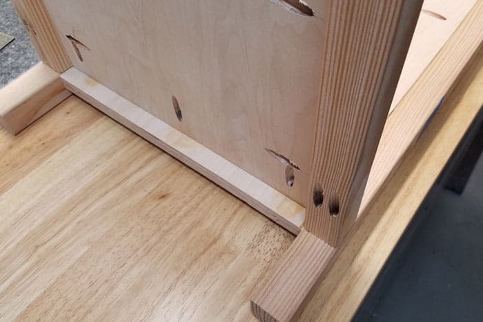 Closeup of bottom attached to side of cabinet.