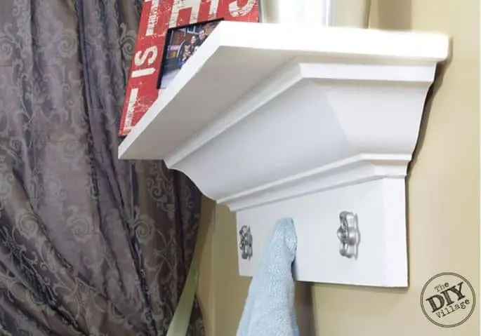 Shelf made from crown molding topped with picture frames.