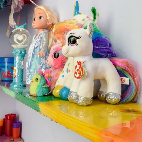 Rainbow painted shelves in little girl's room.