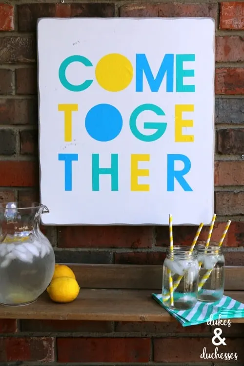 Colorful "Come Together" sign for welcoming porch.