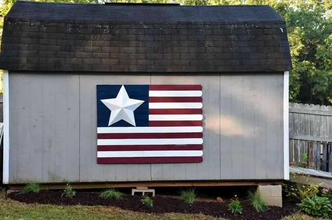 American Flag pickets on side of gray barn.