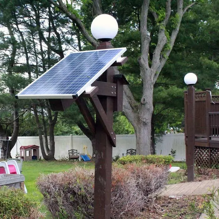 Light Poles with solar panel on side in backyard.