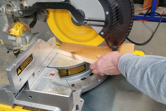 Trimming second angled board on miter saw.