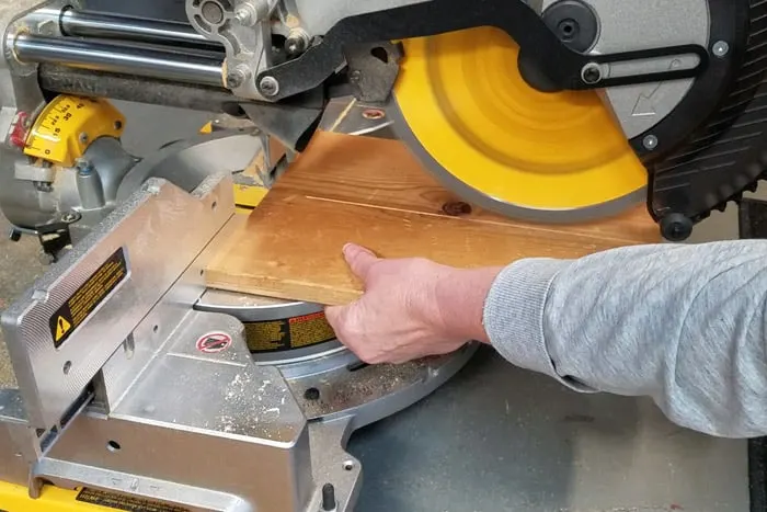 Cutting boards lengthwise on miter saw.