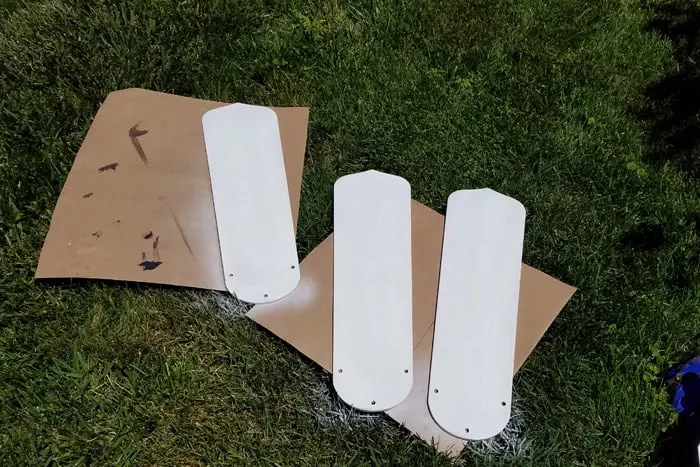 Primed fan blades laying on grass to dry.