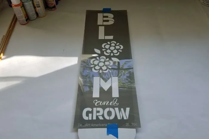 Bloom and Grow Stencil taped to fan blade.