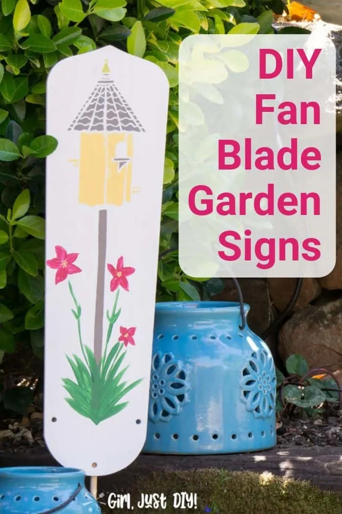 Birdhouse DIY Garden signs from fan blade in garden near blue lantern.