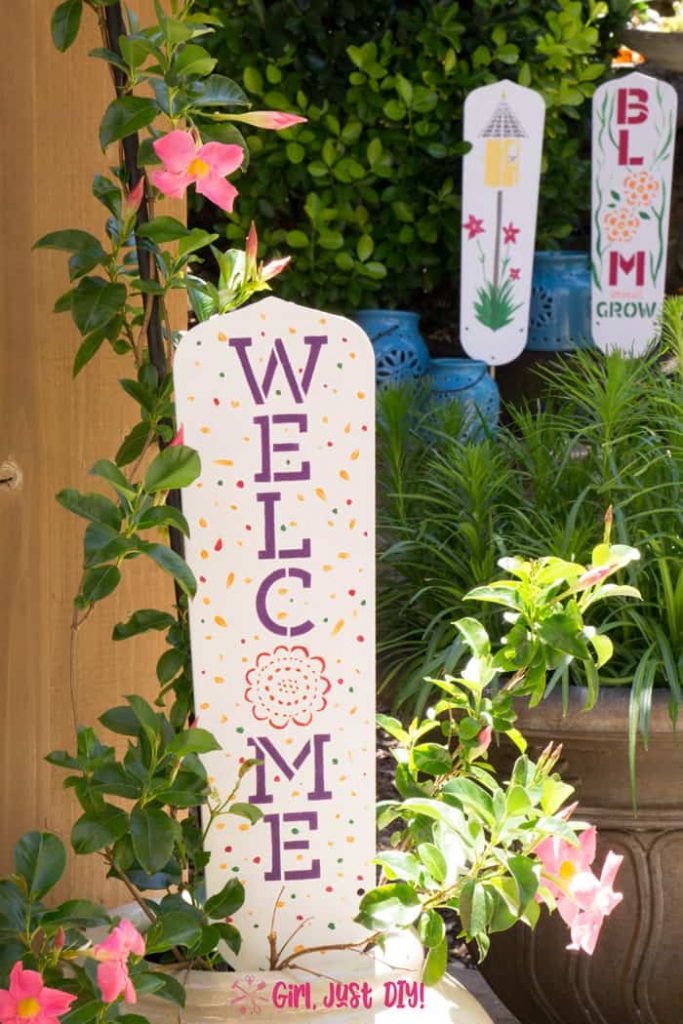 DIY Garden Signs in the garden. One in a pot and two in the flowers.n