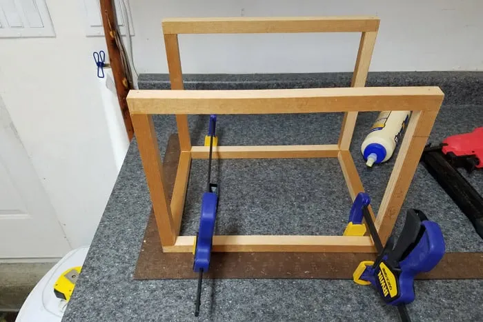 Card box dowel frame held together with clamps.