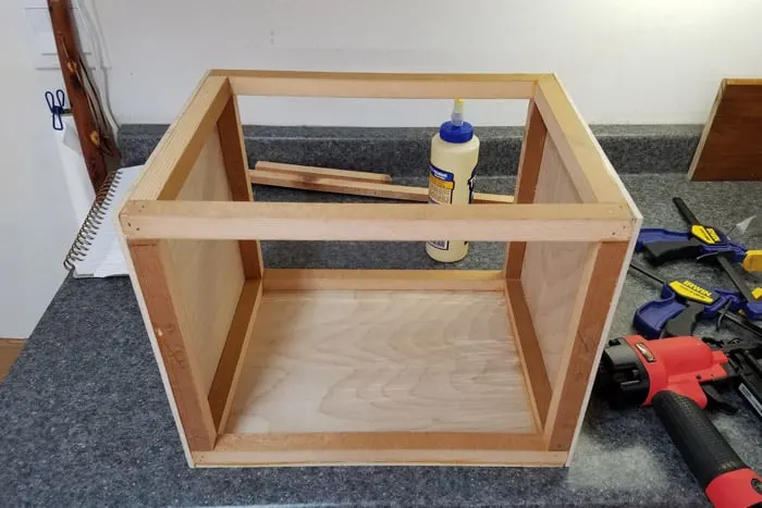 Frame of wedding card box getting covered with plywood sides.