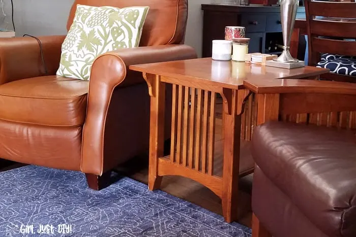 Mission style end table between two side chairs.
