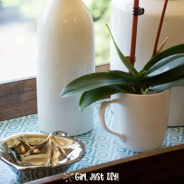 Fast wooden tray updated with ironstone and an orchid on pretty contact paper.